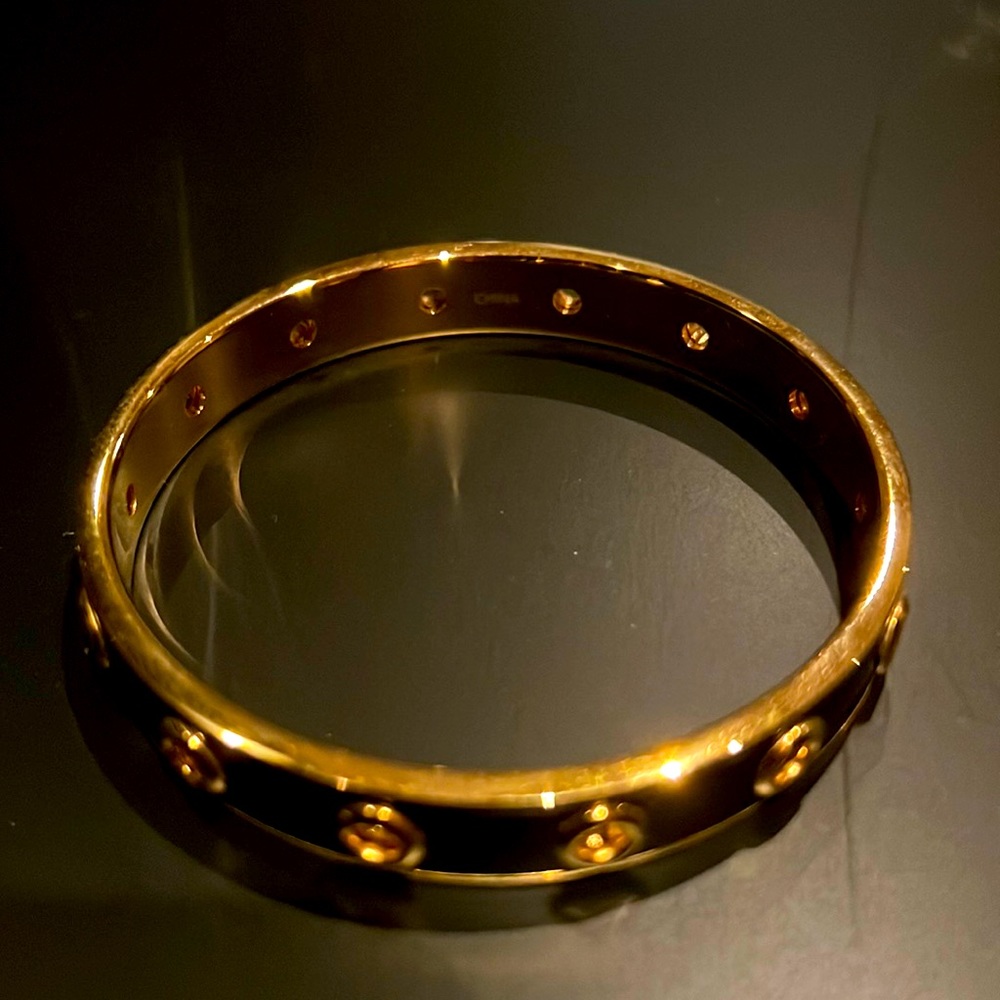 Coach bracelet in black and gold.